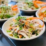 Fresh chicken sesame salad bowls topped with herbs and sesame, perfect for corporate catering or weddings by Catering by Nikki in Christchurch.